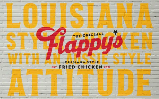 Flappy's Fried Chicken Louisiana-style brand identity painted on a brick wall